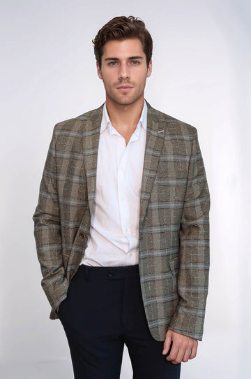Man wearing a plaid blazer over a white shirt and dark pants on a white background