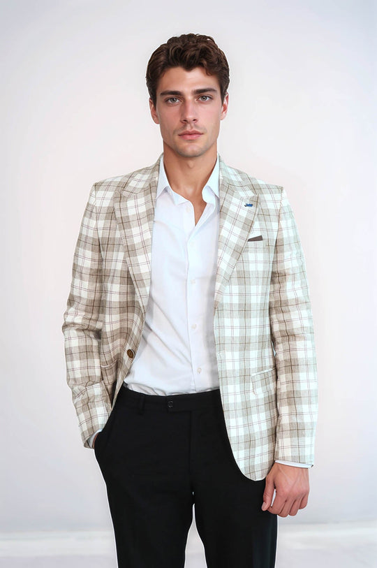 Man wearing a plaid blazer over a white shirt with black pants on a white background