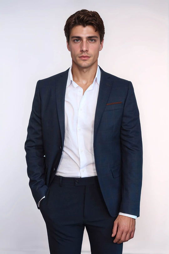 Man wearing a navy blazer and white shirt on a white background
