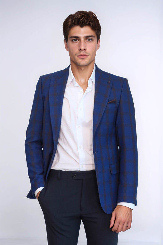 Man wearing a blue checkered suit jacket over a white shirt on a white background