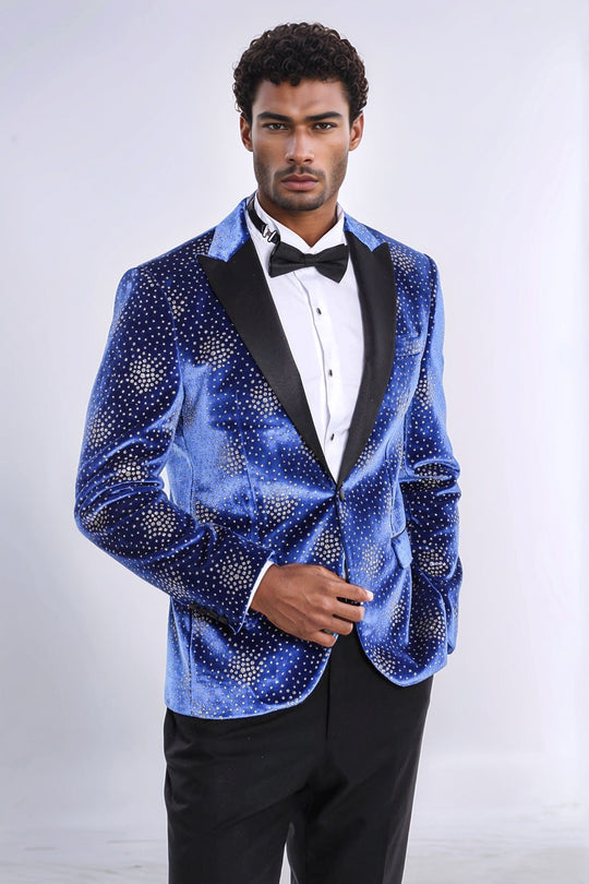 Man wearing a blue sequin tuxedo jacket with a white shirt and black bow tie on a white background