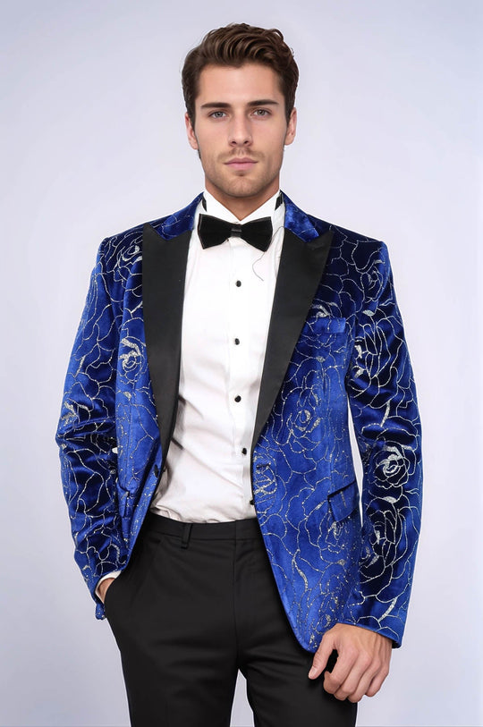 Man wearing a blue floral velvet blazer with black lapels on a white background