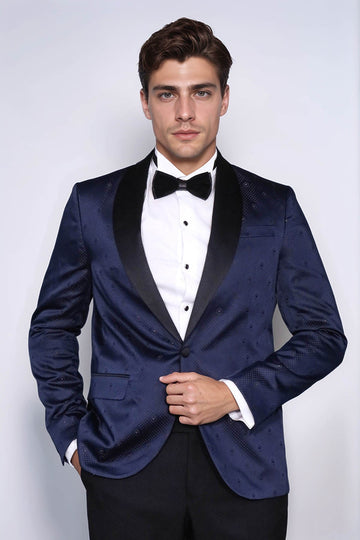 Man wearing a blue tuxedo with a bow tie against a white background