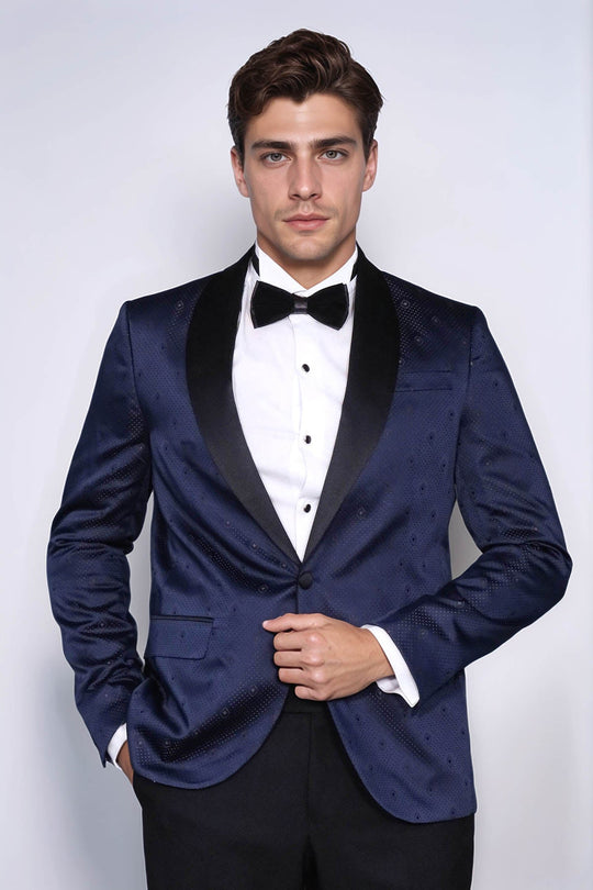 Man wearing a blue tuxedo with a bow tie against a white background