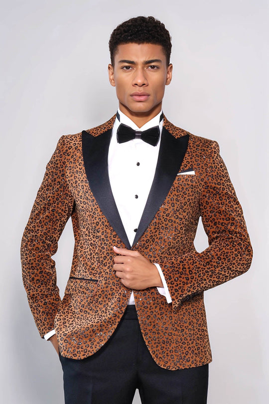 Man wearing a leopard print tuxedo jacket with black lapels on a white background