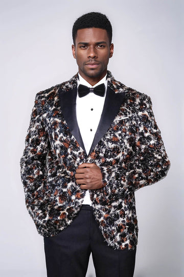 Man wearing a patterned blazer over a tuxedo on a white background