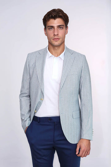 Man wearing a light blue striped blazer, white shirt, and navy pants on a white background