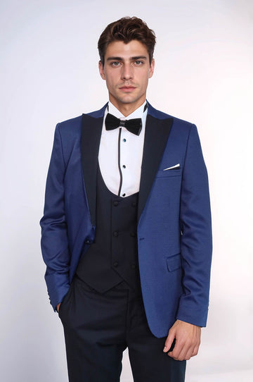 Man wearing a blue suit with a bow tie on a white background