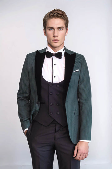 Man wearing a formal green suit with a bow tie on a white background