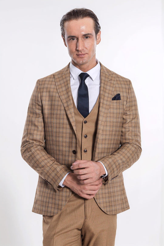 Man wearing a brown checkered suit with a white shirt and dark tie on a white background
