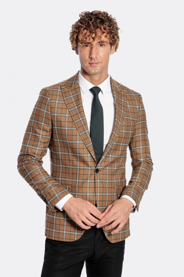 Man wearing a brown checkered blazer with a white shirt and black tie on a white background