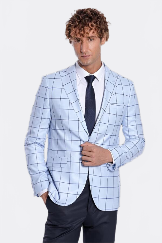 Man wearing a light blue checkered blazer over a white shirt with a dark tie on a light gray background