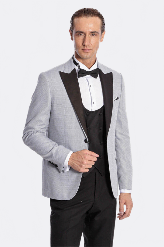 Man wearing a gray tuxedo with a black bow tie on a white background