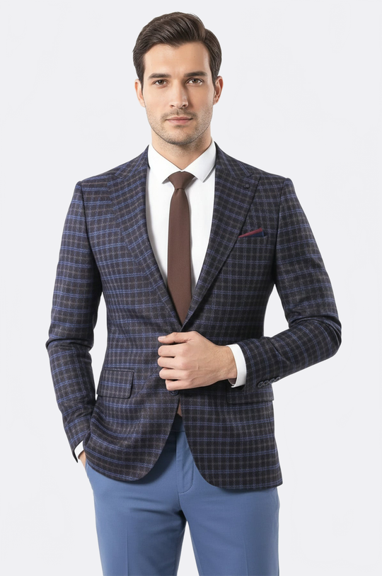 Man wearing a checkered blazer, white shirt, and blue pants on a light gray background