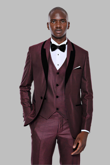 Man wearing a burgundy suit with black lapels and a bow tie on a gray background