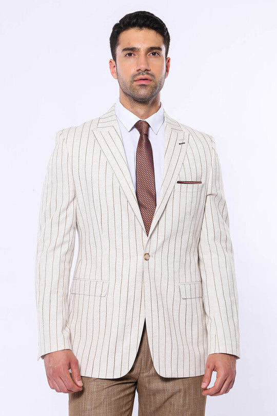Man wearing a cream pinstripe suit with a white shirt and brown tie on a white background
