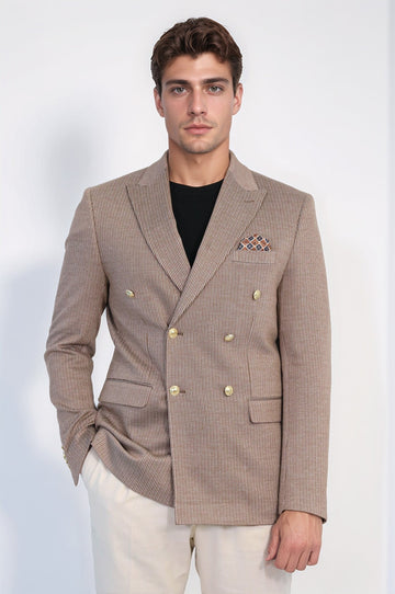 Man wearing a brown checkered blazer with gold buttons on a white background