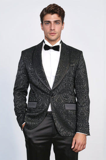 Man wearing a black patterned tuxedo with a white shirt and black bow tie on a light gray background