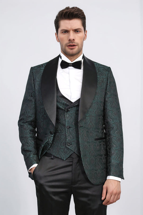 Man wearing a green patterned suit with a bow tie on a white background