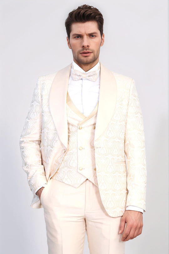 Man wearing a white suit with a bow tie against a plain background